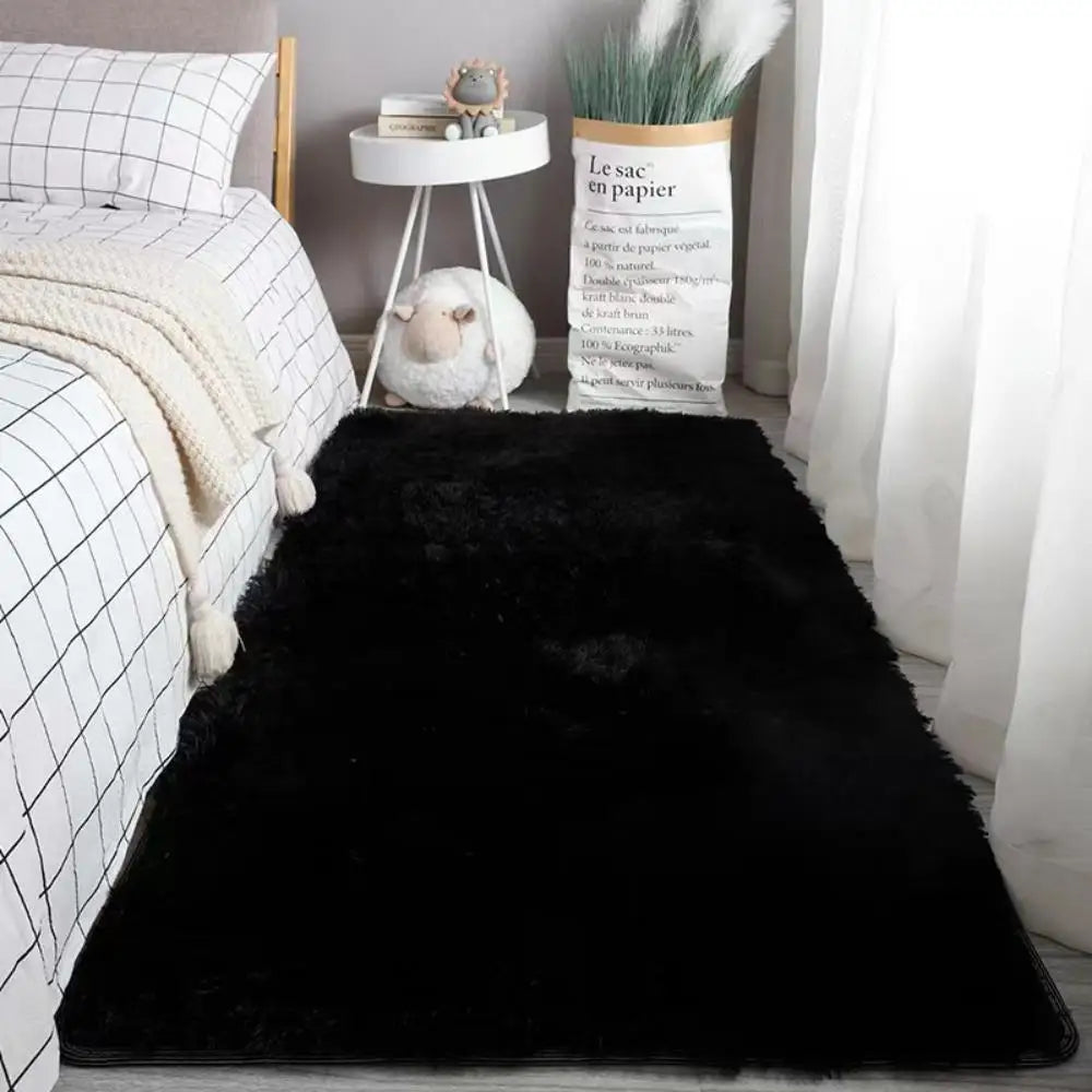 Black rug in a bedroom setting with a bed, nightstand, and decorative items.