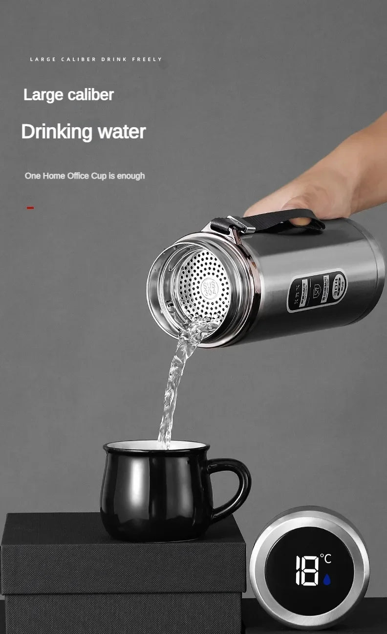 Person pouring water from a large caliber drinking water container into a black mug on a gray background.
