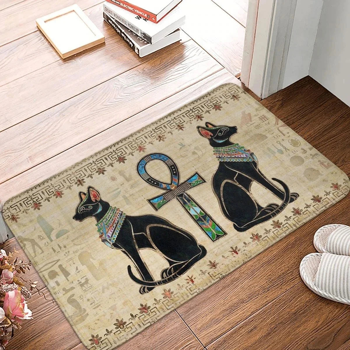 Decorative doormat with Egyptian-themed design on a wooden floor.