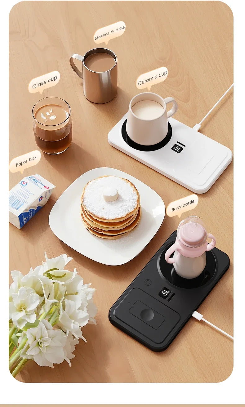 Hot plate with cups, pancakes, and a phone on a wooden surface with flowers.
