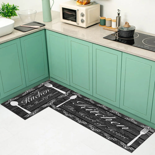 Two kitchen mats with utensils and text on a kitchen floor.