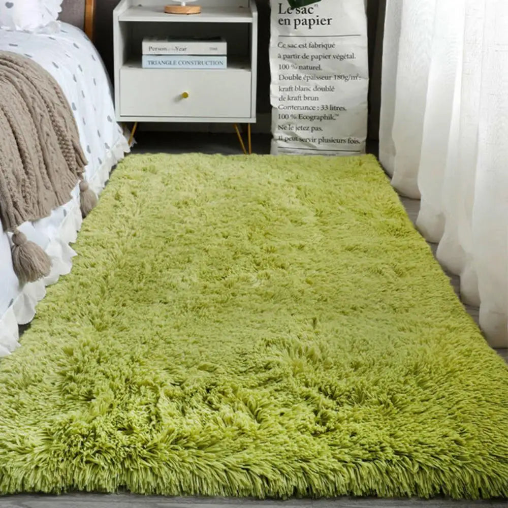 Green shaggy rug in a bedroom setting with a bed and nightstand.