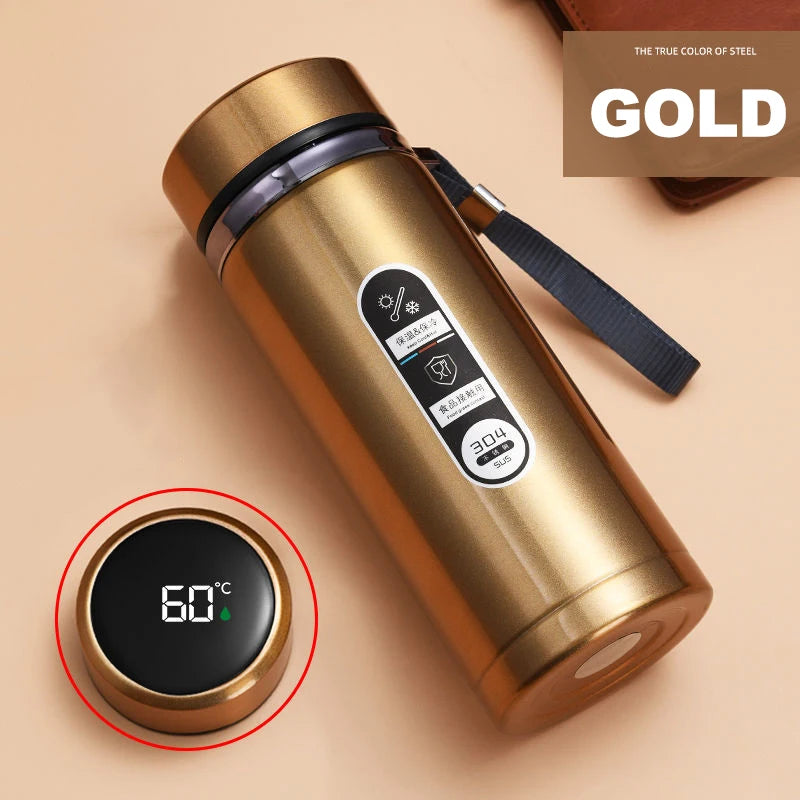 Gold thermos bottle with digital temperature display on a beige background