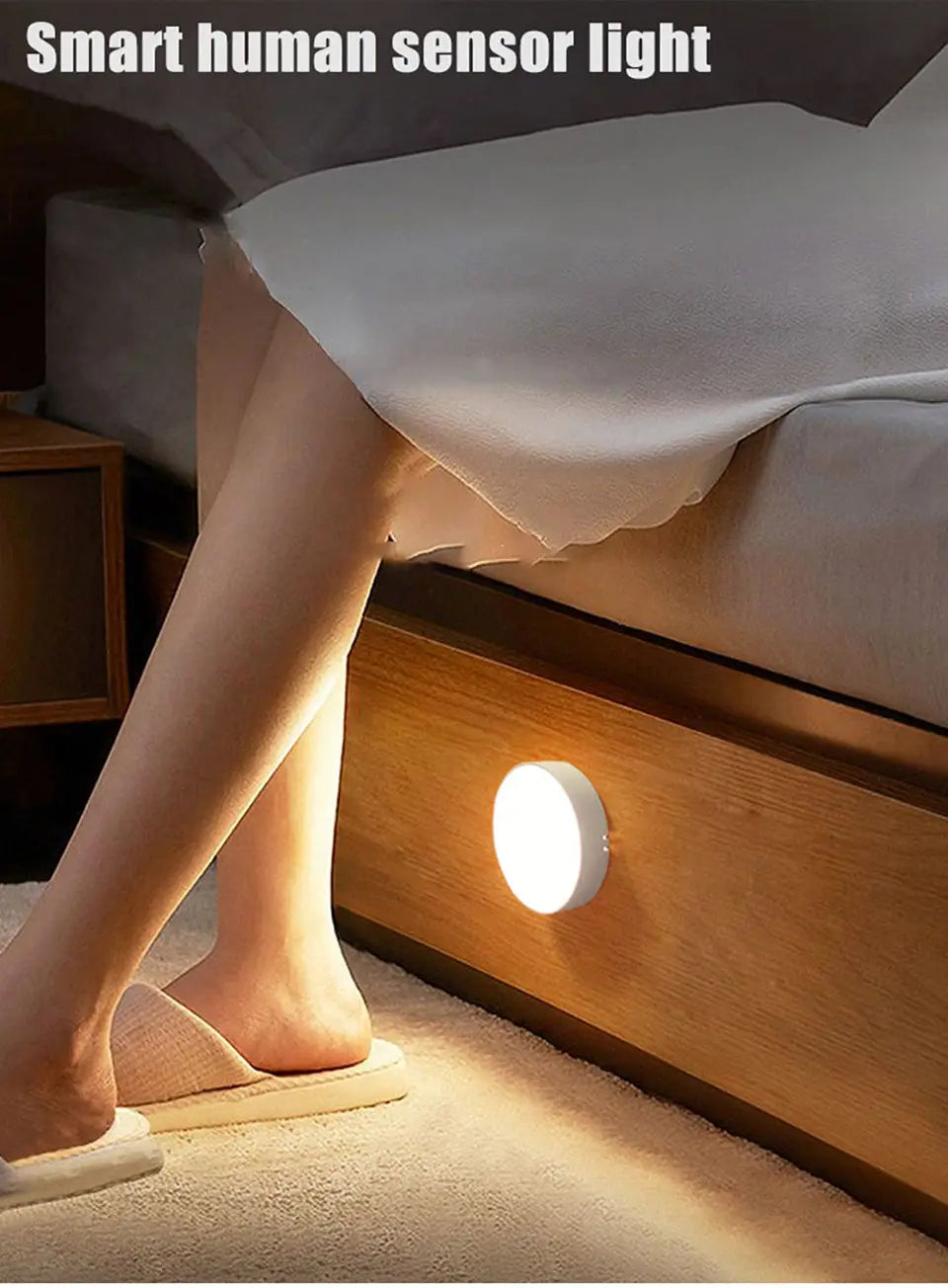 Smart human sensor light on a wooden nightstand next to a bed