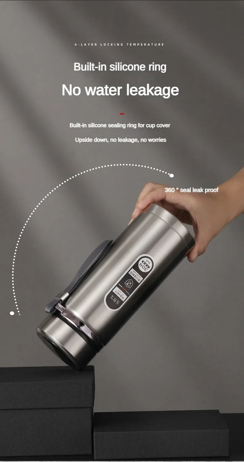 Silver thermos with a hand holding it, on a dark background