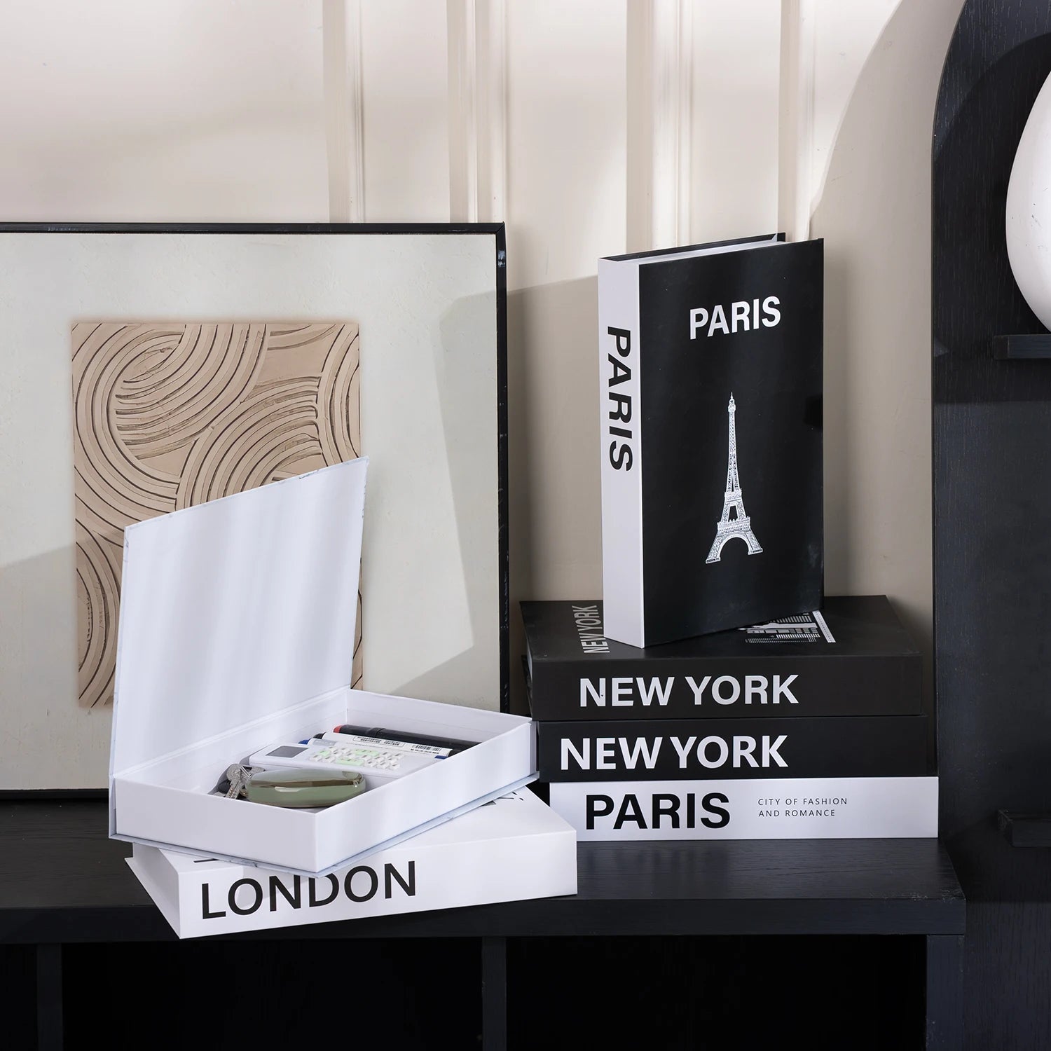 Decorative books titled 'Paris', 'New York', and 'London' on a shelf.