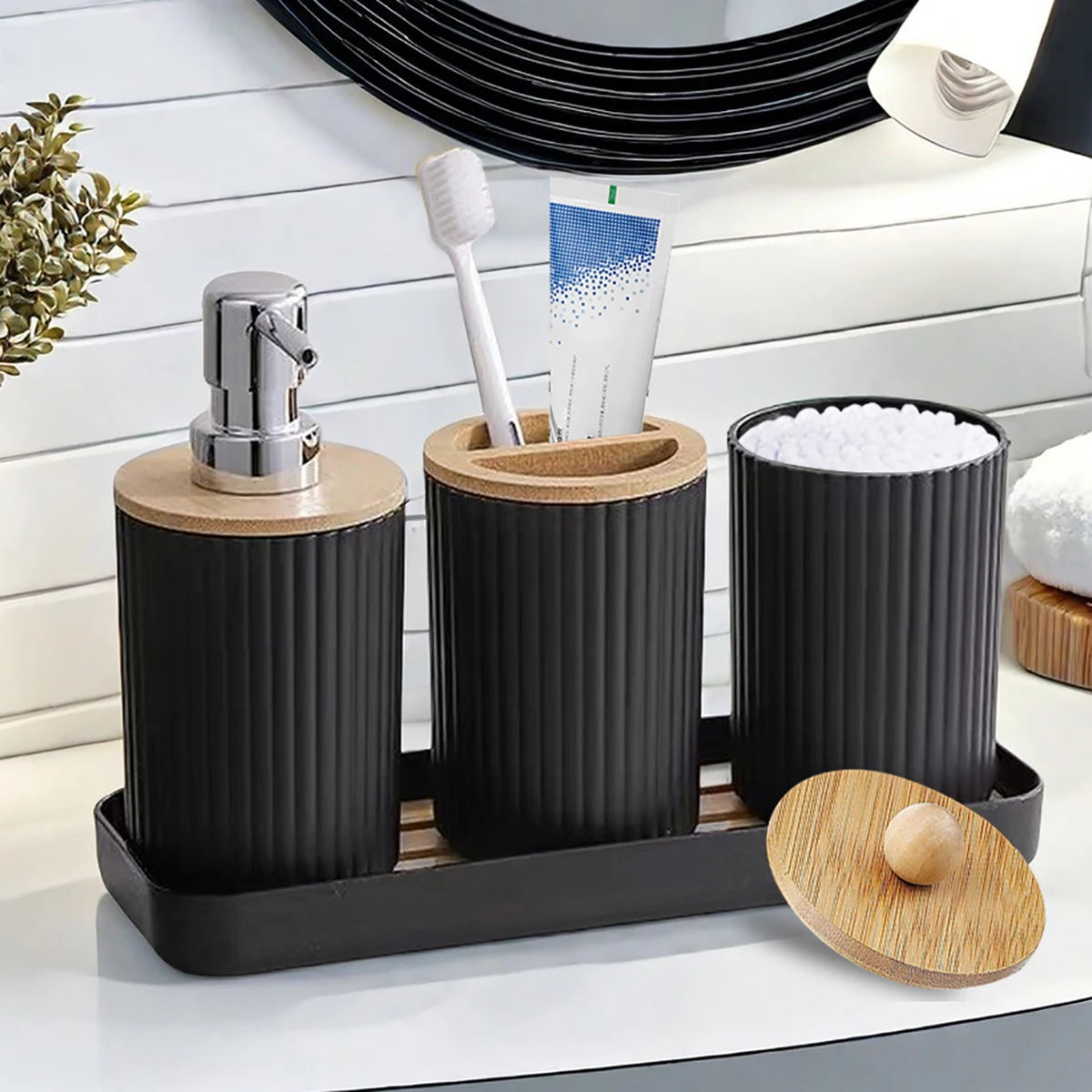 Bathroom counter with black and wooden bathroom accessories including a soap dispenser, toothbrush holder, and container.