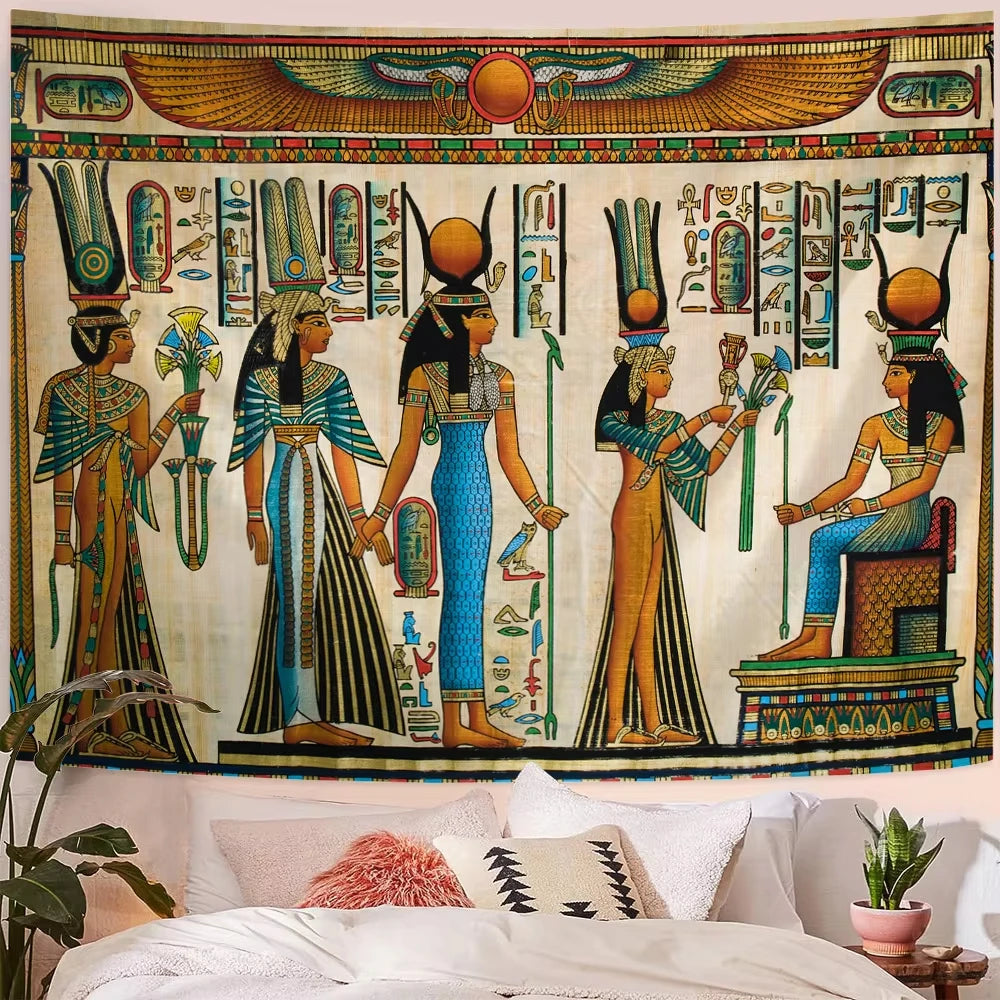 Decorative tapestry with Egyptian-themed design hanging above a bed.