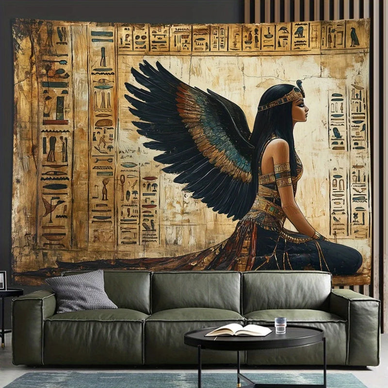 Decorative tapestry with an Egyptian-themed design of a winged figure and hieroglyphs above a sofa.