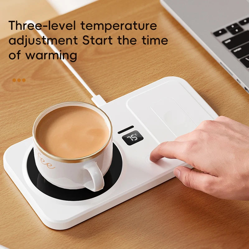 White electric mug warmer with a cup of coffee on a wooden desk, showing temperature adjustment feature.