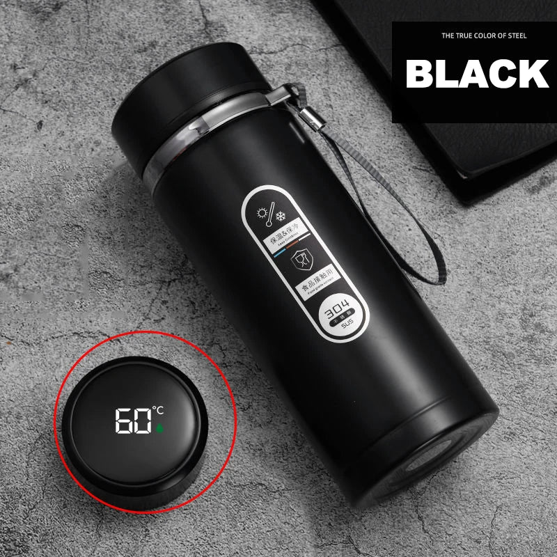 Black thermos bottle with digital temperature display on a gray surface, featuring the brand 'Black'.