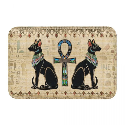Decorative mat with Egyptian-themed design featuring two cats and an ankh symbol on a beige background.