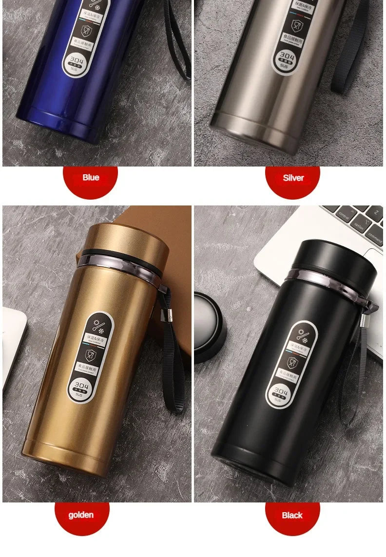 Four different colored thermos bottles on a gray surface with color labels.