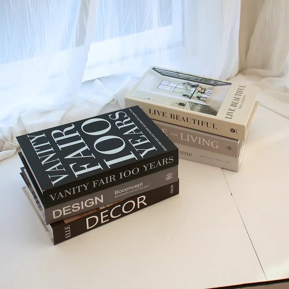 Stack of design books on a light surface with a blurred background