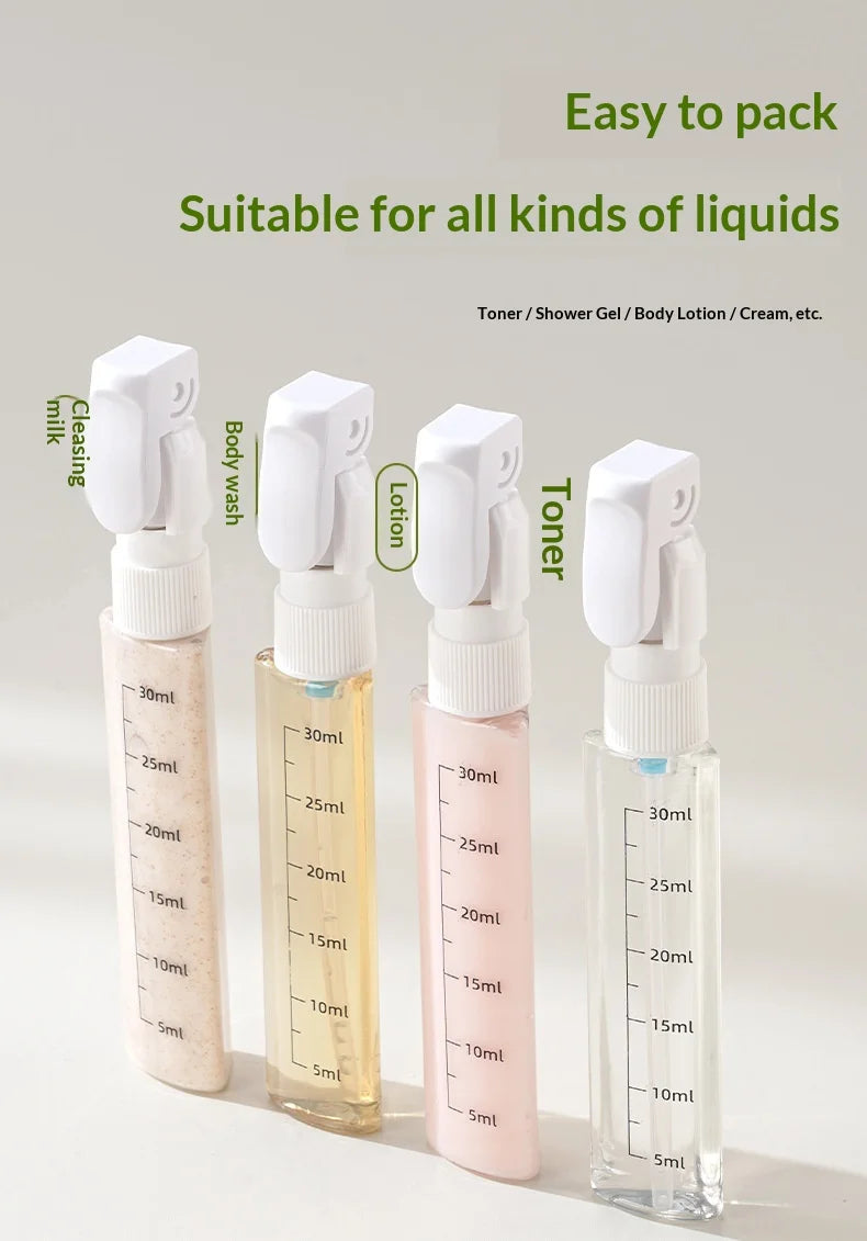 Set of four small spray bottles with measurement markings on a light gray background.