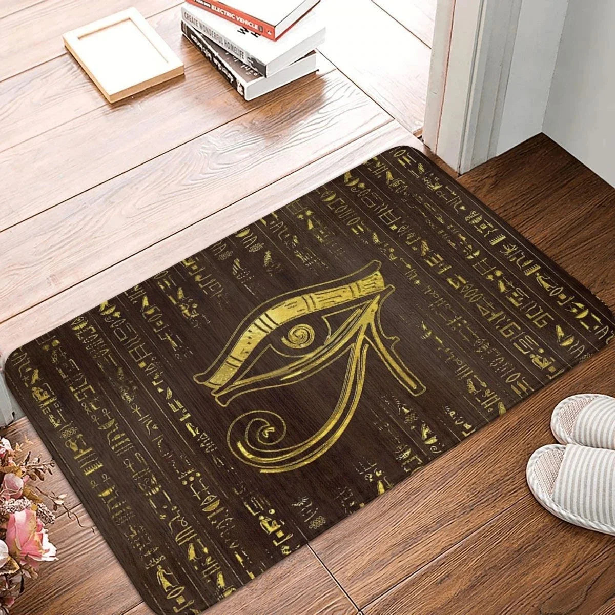 Decorative doormat with Egyptian Eye of Horus design on a wooden floor.