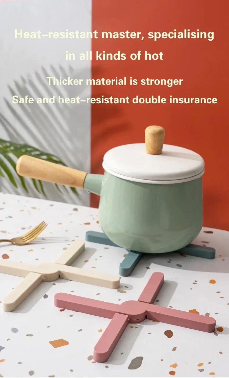 Green pot with wooden handle on a white surface with text about heat resistance and safety.