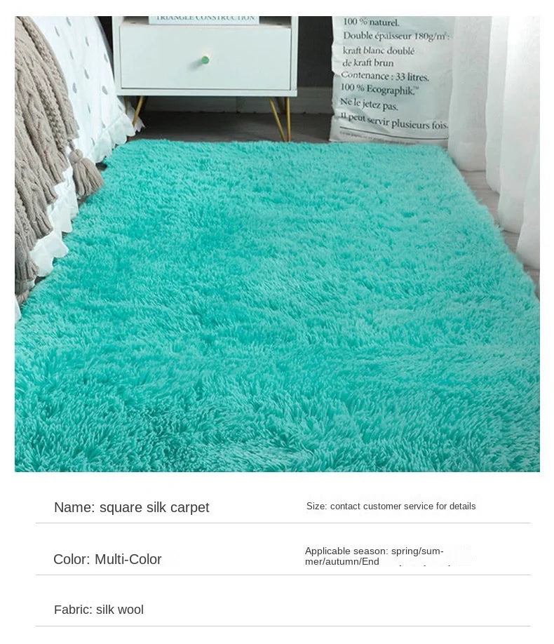 Turquoise square silk carpet in a room setting with furniture.