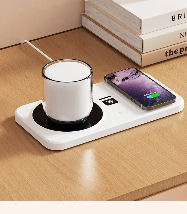 White electric mug warmer with a glass of milk and a smartphone on a wooden surface.