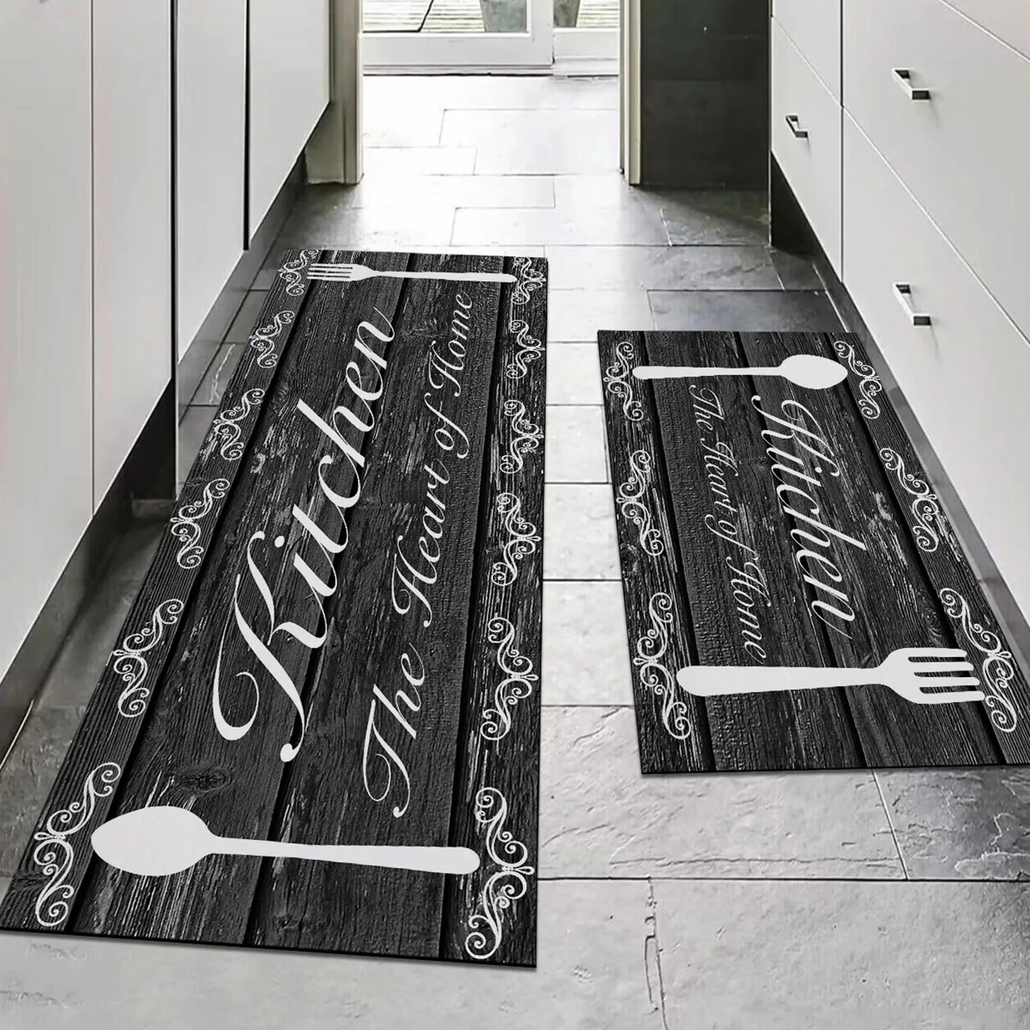 Two kitchen mats with 'Kitchen The Heart of Home' text and spoon designs on a wooden floor.